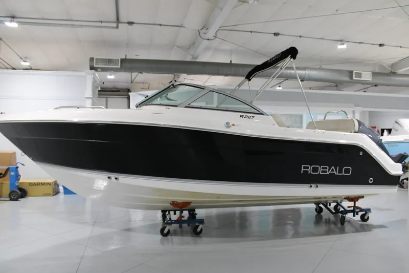 Slide: The Image of 2005 Robalo R227 Dual Console boat displayed indoors on wheeled supports. - 3