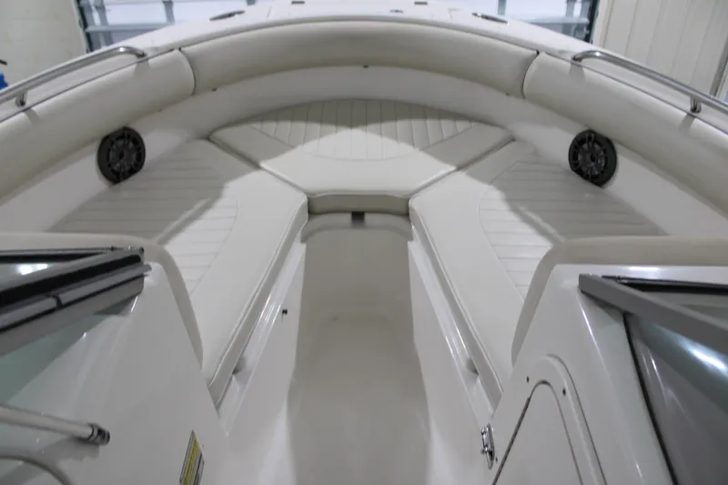 Slide: The Image of 2005 Robalo R227 Dual Console boat interior with white seating and speakers. - 30
