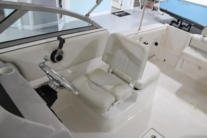 Slide: The Image of 2005 Robalo R227 Dual Console boat interior with steering wheel and seating. - 26