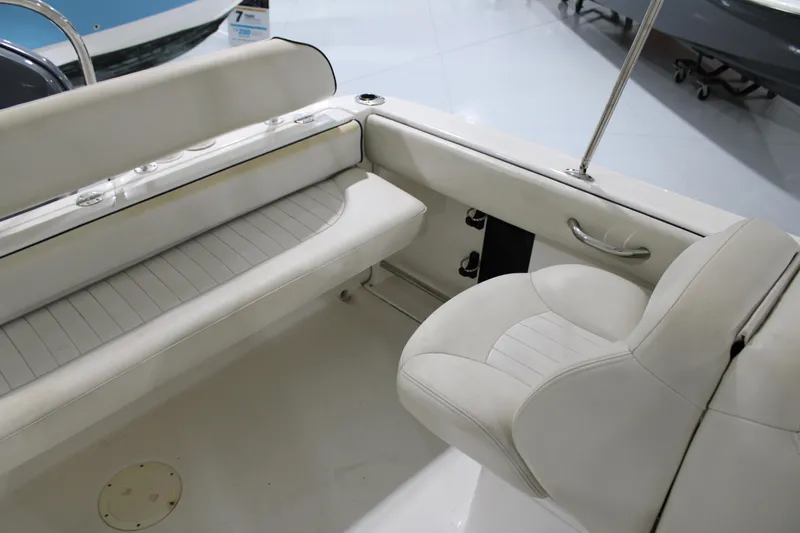 Slide: The Image of 2005 Robalo R227 Dual Console boat interior with white seating and sleek design. - 10