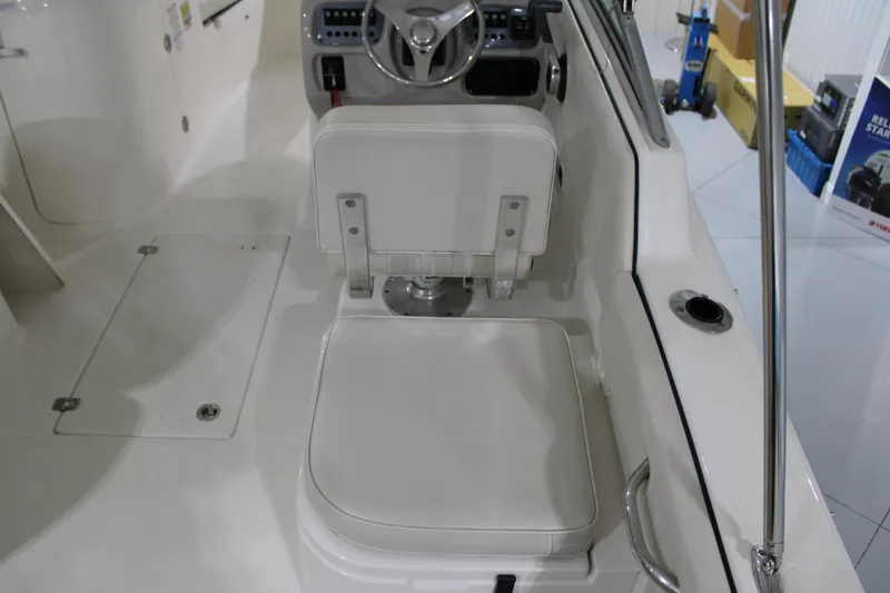 Slide: The Image of 2005 Robalo R227 Dual Console boat interior with steering wheel and seating. - 8