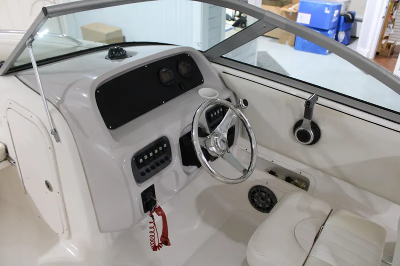 Slide: The Image of 2005 Robalo R227 Dual Console boat interior with steering wheel and dashboard controls. - 25