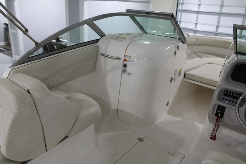 Slide: The Image of 2005 Robalo R227 Dual Console boat interior with white seating and dashboard. - 16