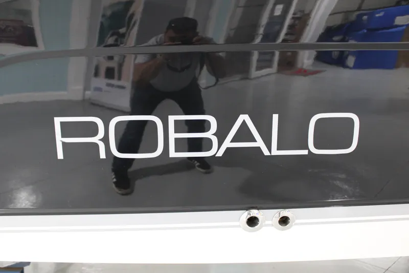 Slide: The Image of 2005 Robalo R227 Dual Console boat with reflective surface and logo. - 39