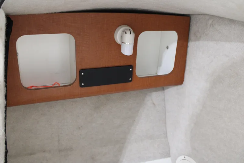 Slide: The Image of Interior cabin of 2005 Robalo R227 Dual Console boat, featuring storage compartments. - 21