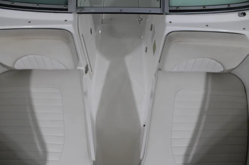 Slide: The Image of 2005 Robalo R227 Dual Console boat interior with white seating and sleek design. - 31