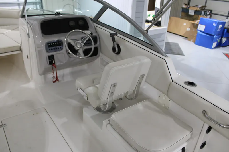 Slide: The Image of 2005 Robalo R227 Dual Console boat interior with steering wheel and seating. - 9