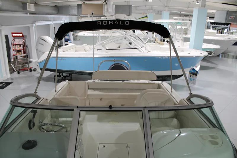 Slide: The Image of 2005 Robalo R227 Dual Console boat in showroom, featuring sleek design and spacious interior. - 35
