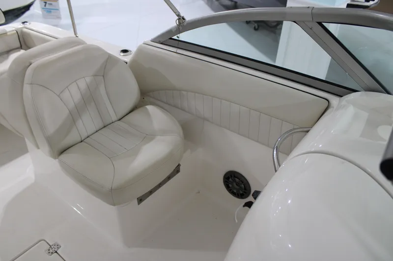 Slide: The Image of 2005 Robalo R227 Dual Console boat interior with white seating and speaker. - 18