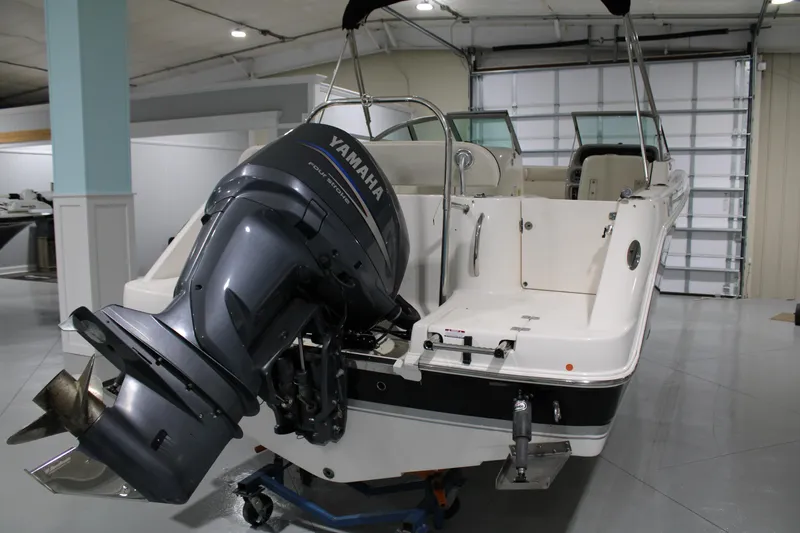 Slide: The Image of 2005 Robalo R227 Dual Console boat with Yamaha outboard motor in a garage. - 7