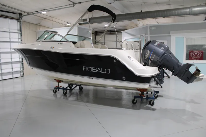 Slide: The Image of 2005 Robalo R227 Dual Console boat in showroom, side view. - 1