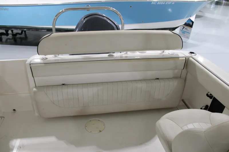 Slide: The Image of 2005 Robalo R227 Dual Console boat interior with white seating and storage. - 12