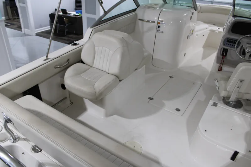 Slide: The Image of 2005 Robalo R227 Dual Console boat interior with white seating and dashboard. - 15