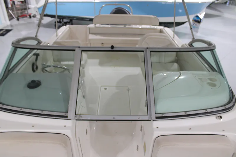 Slide: The Image of 2005 Robalo R227 Dual Console boat interior with windshield and seating. - 27