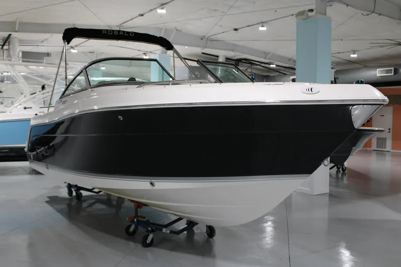 Slide: The Image of 2005 Robalo R227 Dual Console boat displayed indoors on a stand. - 4