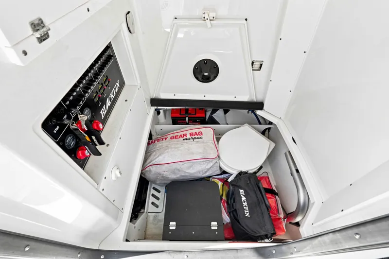 Slide: The Image of Interior of 2021 Blackfin 272 CC boat showing storage area with safety gear and equipment. - 24