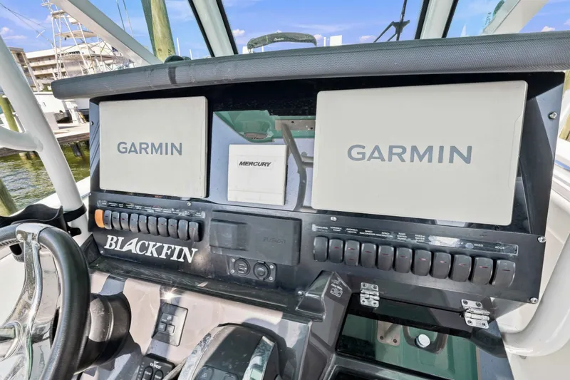 Slide: The Image of 2021 Blackfin 272 CC boat dashboard with Garmin and Mercury displays. - 23