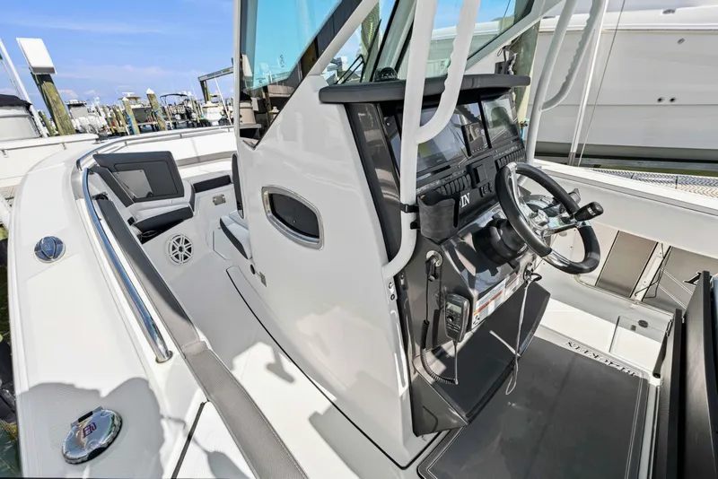 Slide: The Image of 2021 Blackfin 272 CC boat cockpit with modern steering and navigation controls. - 16
