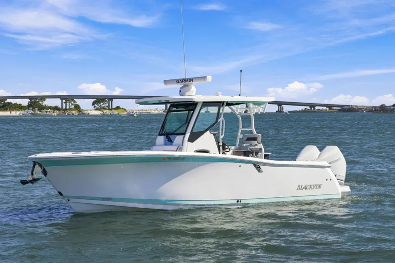 The Image of 2021 Blackfin 272 CC boat on water with clear sky and distant bridge. - 1