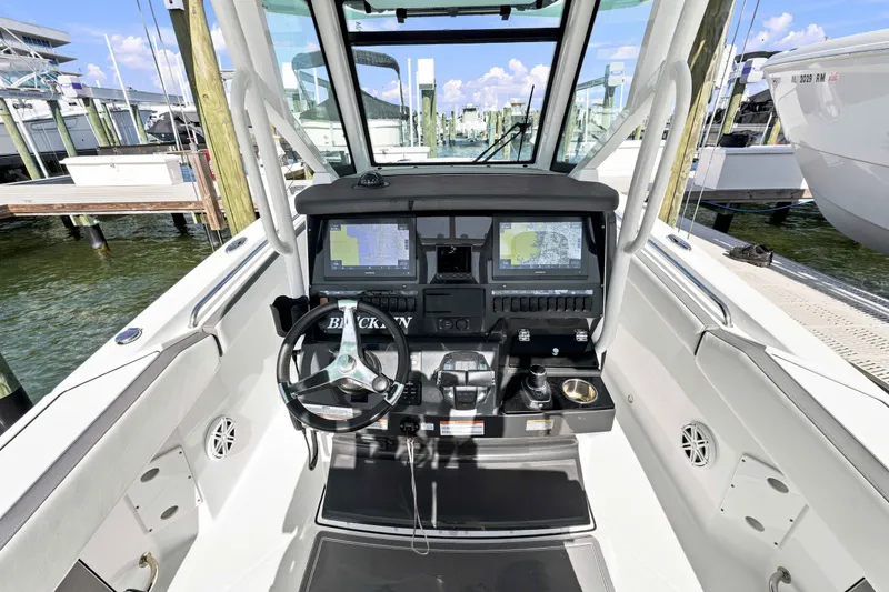 Slide: The Image of 2021 Blackfin 272 CC boat cockpit with advanced navigation system and steering wheel. - 14