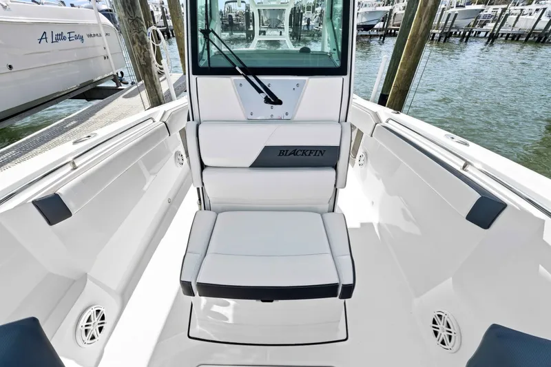 Slide: The Image of 2021 Blackfin 272 CC boat interior with seating, docked at marina. - 18