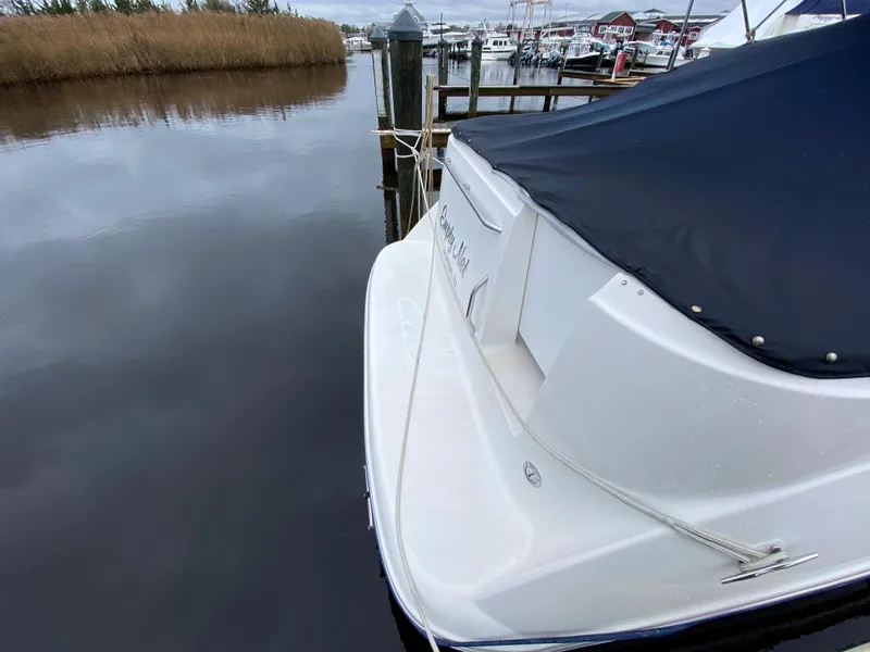 Slide: The Image of The image shows the stern of a 2002 Bayliner 2655 Ciera docked at a pier. - 17