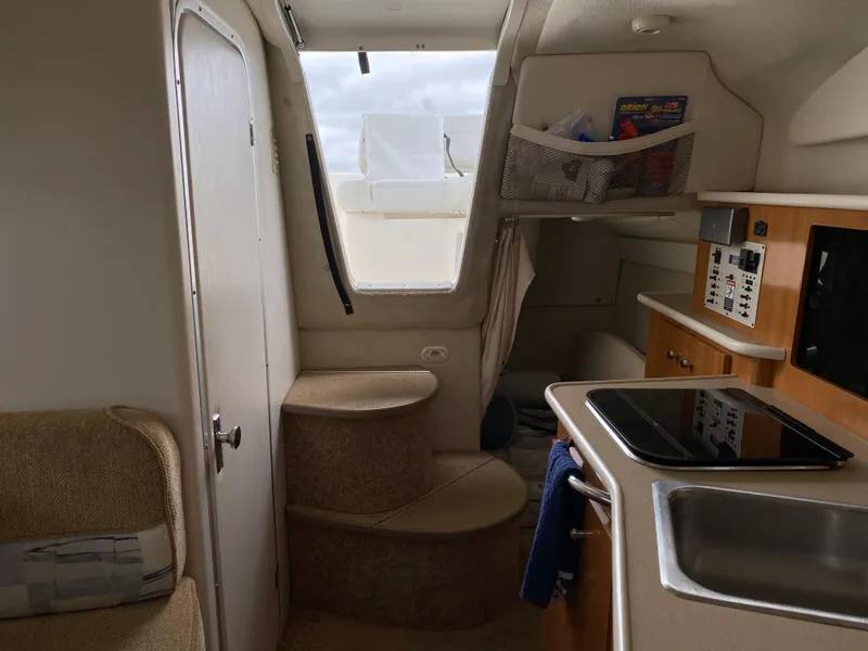 Slide: The Image of Interior of a 2002 Bayliner 2655 Ciera with a kitchenette and stairs. - 12