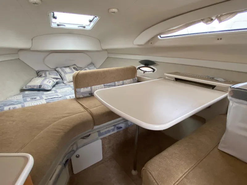 Slide: The Image of Interior of the 2002 Bayliner 2655 Ciera with cozy seating area and table. - 11