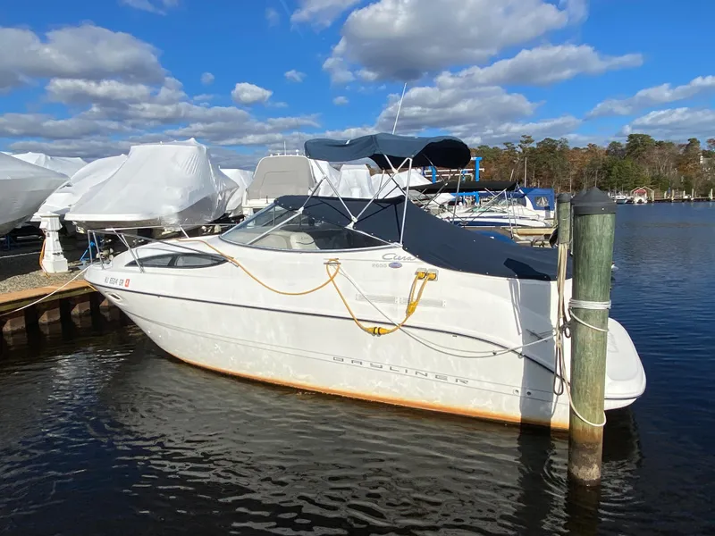 Slide: The Image of 2002 Bayliner 2655 Ciera docked with blue cover and ropes. - 3