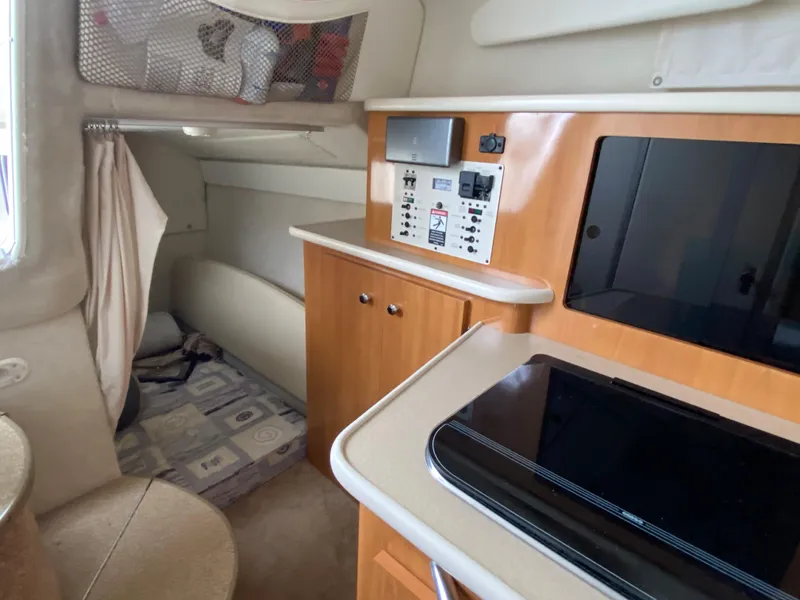 Slide: The Image of Interior of the 2002 Bayliner 2655 Ciera featuring a kitchenette and seating area. - 16