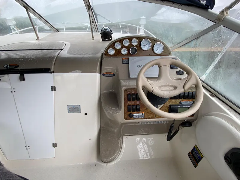 Slide: The Image of The image shows the cockpit of a 2002 Bayliner 2655 Ciera with a steering wheel and instruments. - 5