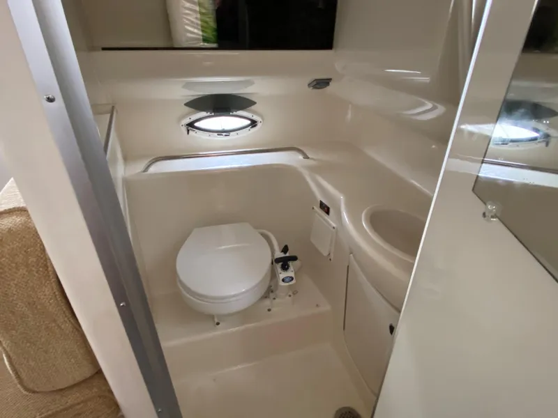 Slide: The Image of The image shows the bathroom of a 2002 Bayliner 2655 Ciera with a toilet and sink. - 14