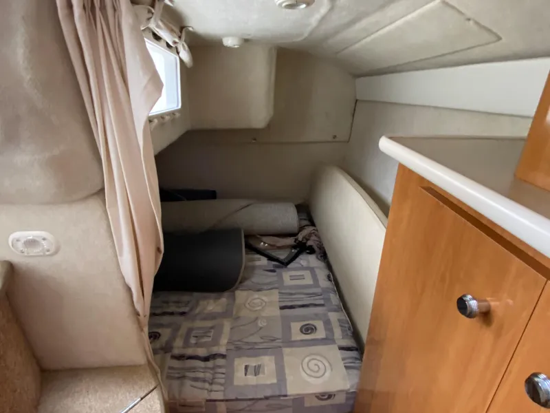 Slide: The Image of Interior of a 2002 Bayliner 2655 Ciera with a bed and storage space. - 15