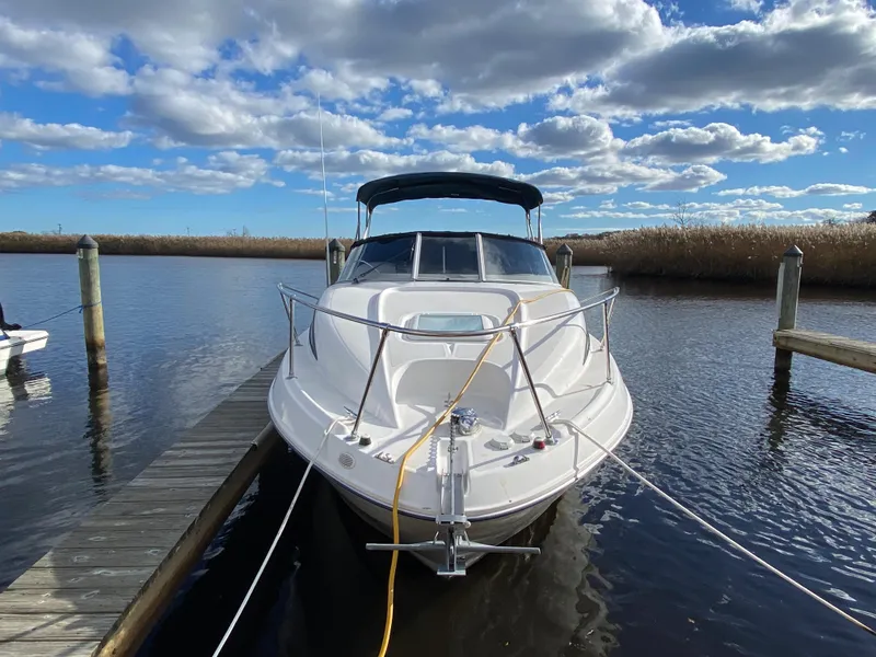 Slide: The Image of 2002 Bayliner 2655 Ciera docked, surrounded by water and reeds. - 2
