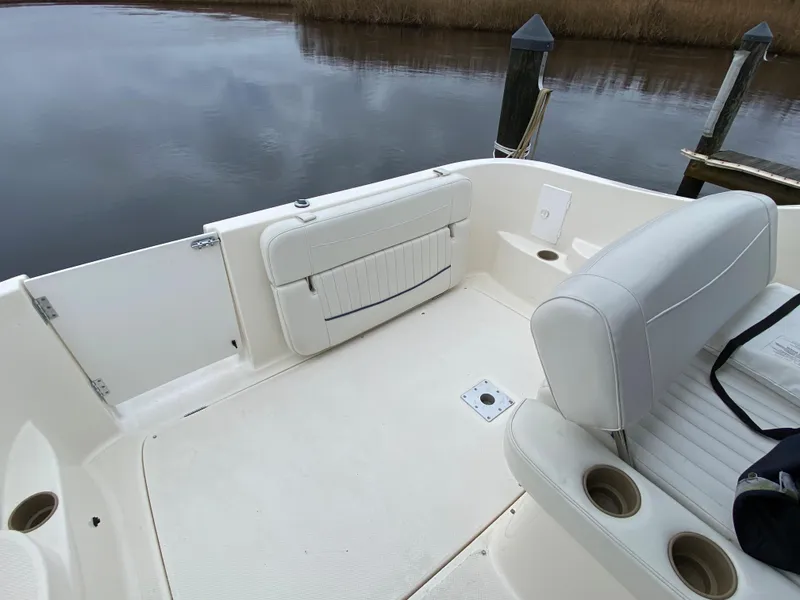 Slide: The Image of The image shows the cockpit of a 2002 Bayliner 2655 Ciera with white seating and cup holders. - 8