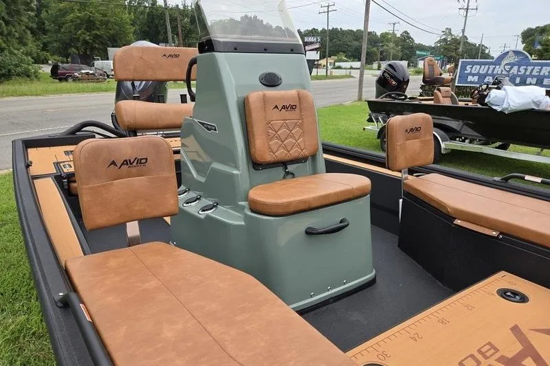 Slide: The Image of 2027 Avid 207 Recon boat with tan leather seats and central console. - 14