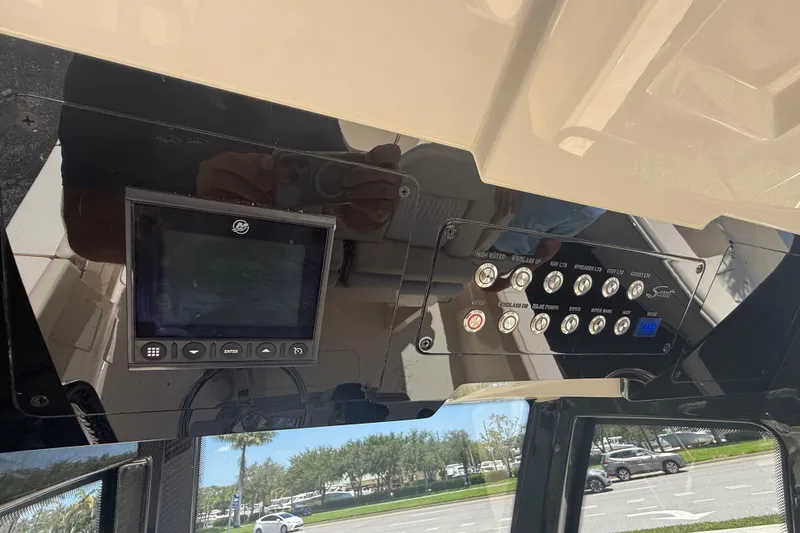 Slide: The Image of Control panel of a 2027 Scout 260 LXF boat with digital display and switches. - 15