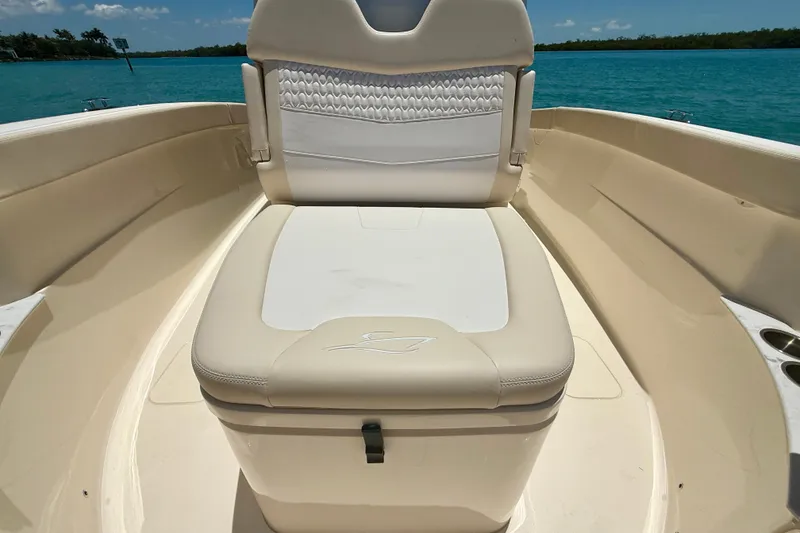 Slide: The Image of 2027 Scout 260 LXF boat interior with cushioned seating and ocean view. - 18