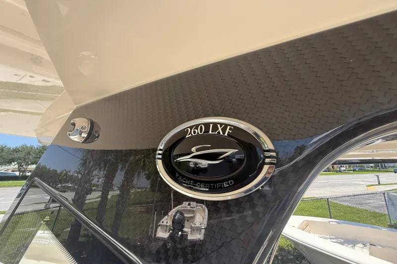 Slide: The Image of 2027 Scout 260 LXF yacht-certified emblem on sleek carbon fiber finish. - 16