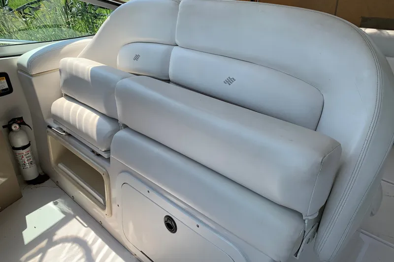 Slide: The Image of 2005 Four Winns 328 Vista boat interior with white cushioned seating and fire extinguisher. - 16