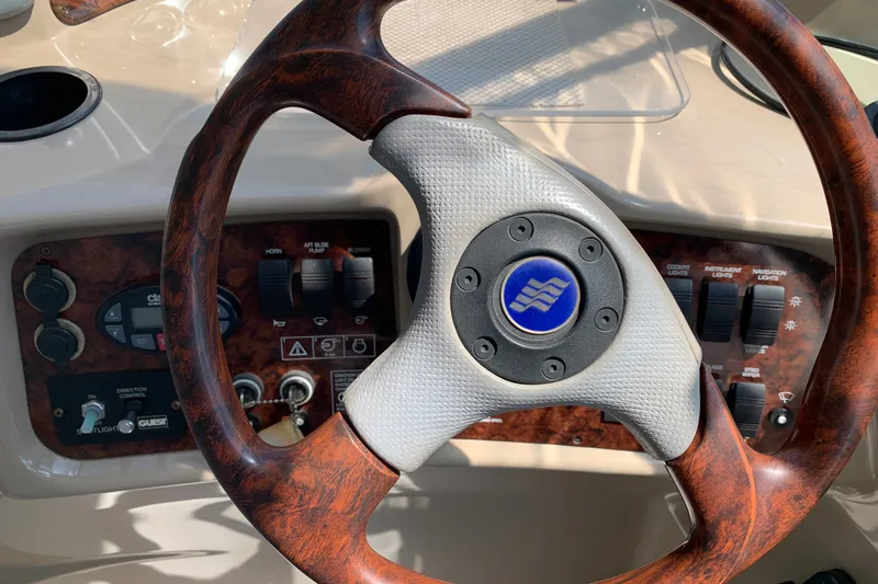 Slide: The Image of Steering wheel and dashboard of 2005 Four Winns 328 Vista boat. - 19