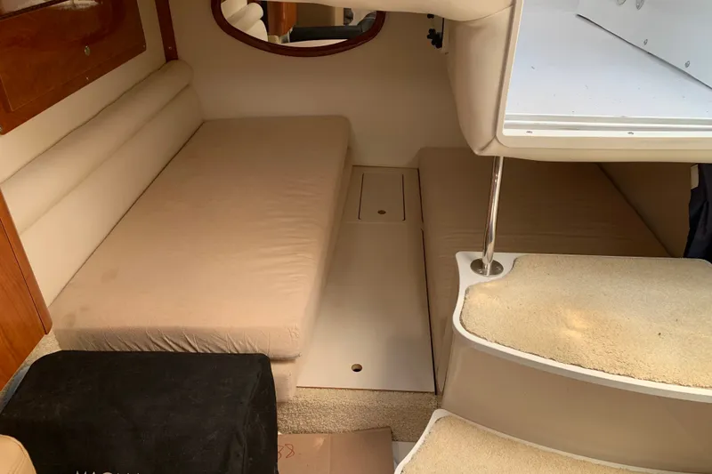 Slide: The Image of Interior cabin of 2005 Four Winns 328 Vista boat with beige seating and steps. - 26