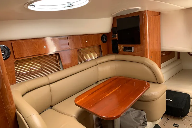 Slide: The Image of Luxurious interior of 2005 Four Winns 328 Vista yacht with leather seating and wooden accents. - 23