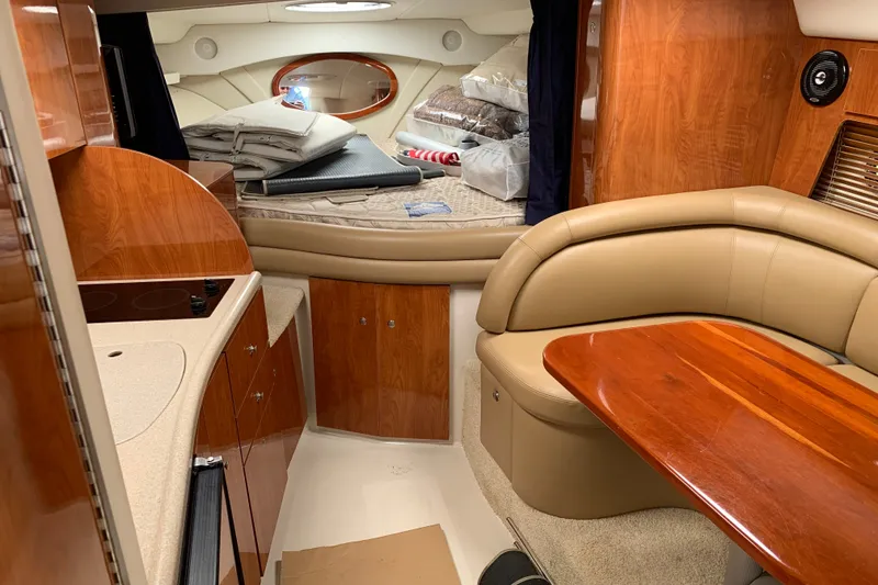 Slide: The Image of Interior of 2005 Four Winns 328 Vista boat with wood finishes and cozy seating area. - 21