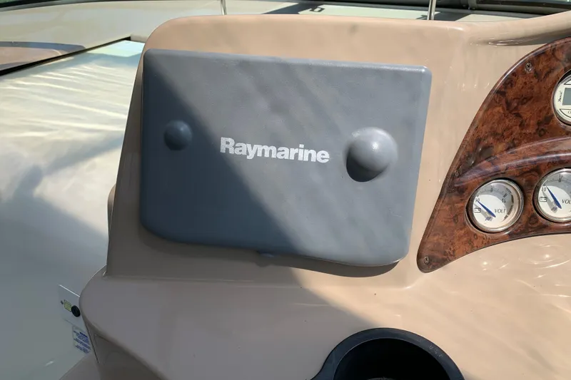 Slide: The Image of 2005 Four Winns 328 Vista dashboard with Raymarine cover and voltmeter gauges. - 20