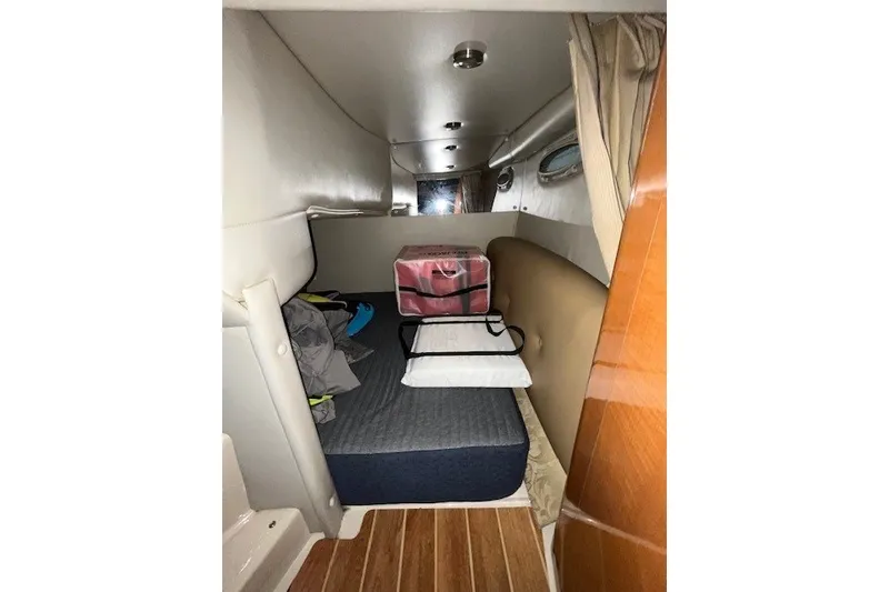 Slide: The Image of 2007 Chaparral Signature 280 cabin interior with bed and storage. - 16