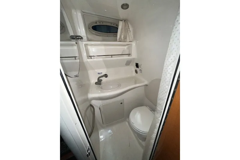 Slide: The Image of Bathroom interior of 2007 Chaparral Signature 280 boat, featuring sink and toilet. - 14