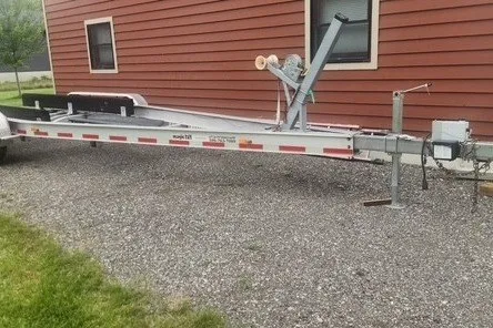 Slide: The Image of Trailer for 2007 Chaparral Signature 280 boat parked beside a red building. - 22