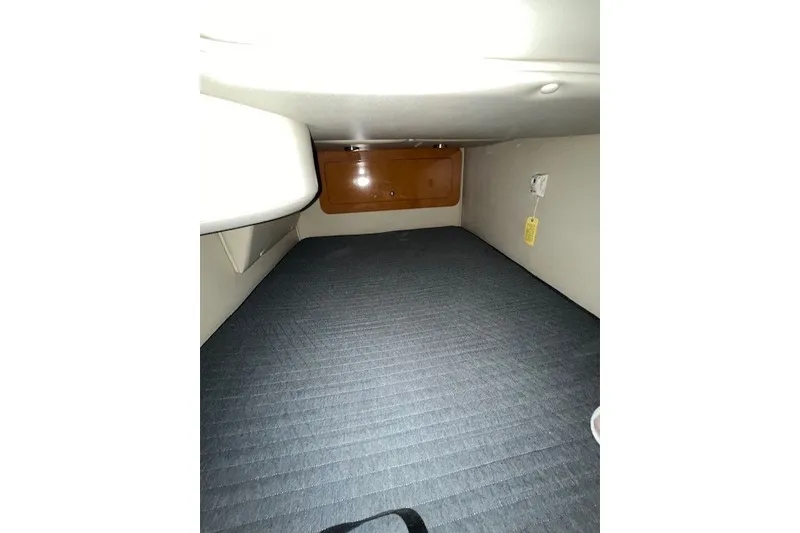 Slide: The Image of Interior cabin of 2007 Chaparral Signature 280 boat, featuring a compact sleeping area. - 17