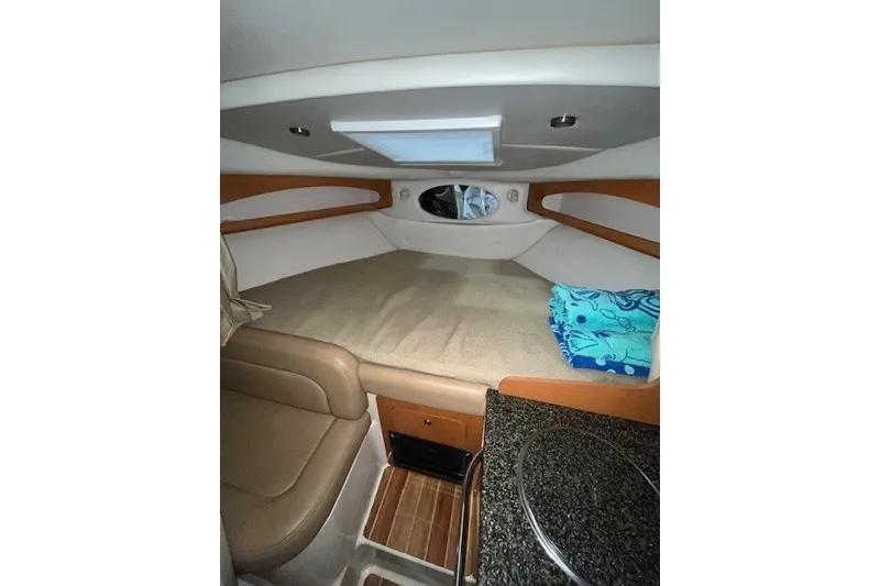 Slide: The Image of Interior cabin of 2007 Chaparral Signature 280 boat, featuring cozy sleeping area. - 13
